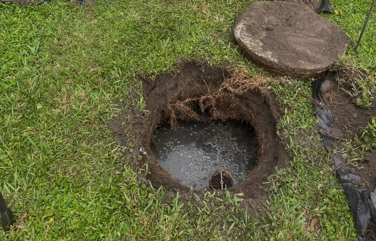 Septic tank opened in a front lawn, ready to be pumped